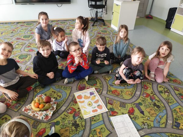Przedszkolaki wskazują który owoc należy pokolorować według jego nazwy