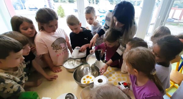 Misie z pomocą wychowawczyń robią gofry.