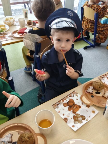 Kacperek bierze udział w poczęstunku podczas balu karnawałowego.