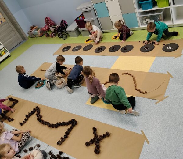 Misie biorą udział w zabawach sensorycznych z wykorzystaniem darów jesieni.